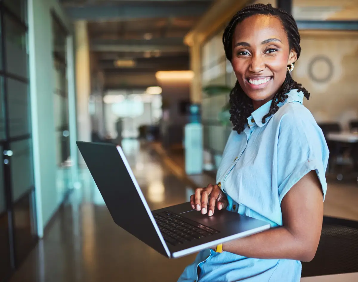 Smiling woman working on a laptop